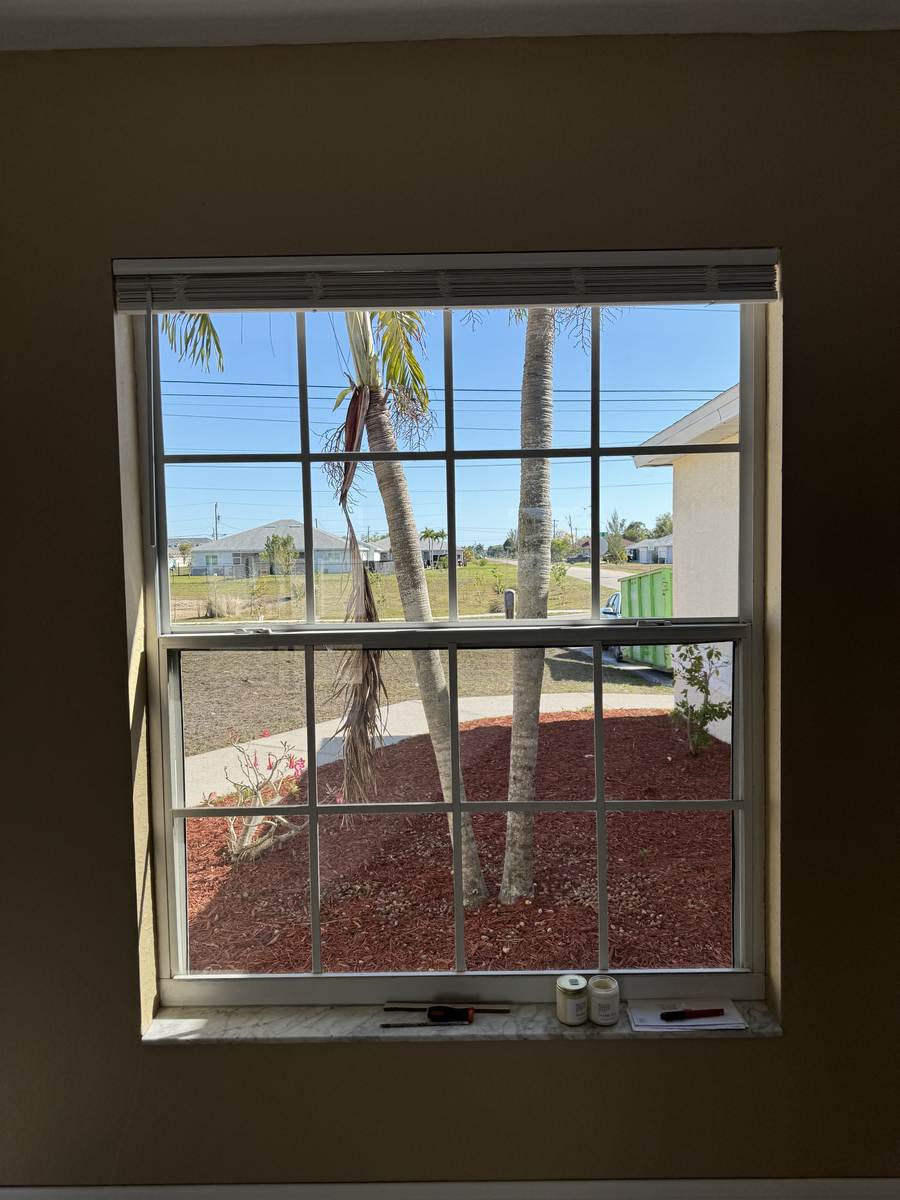 Interior view through a newly cleaned grid window at a new construction home in Cape Coral